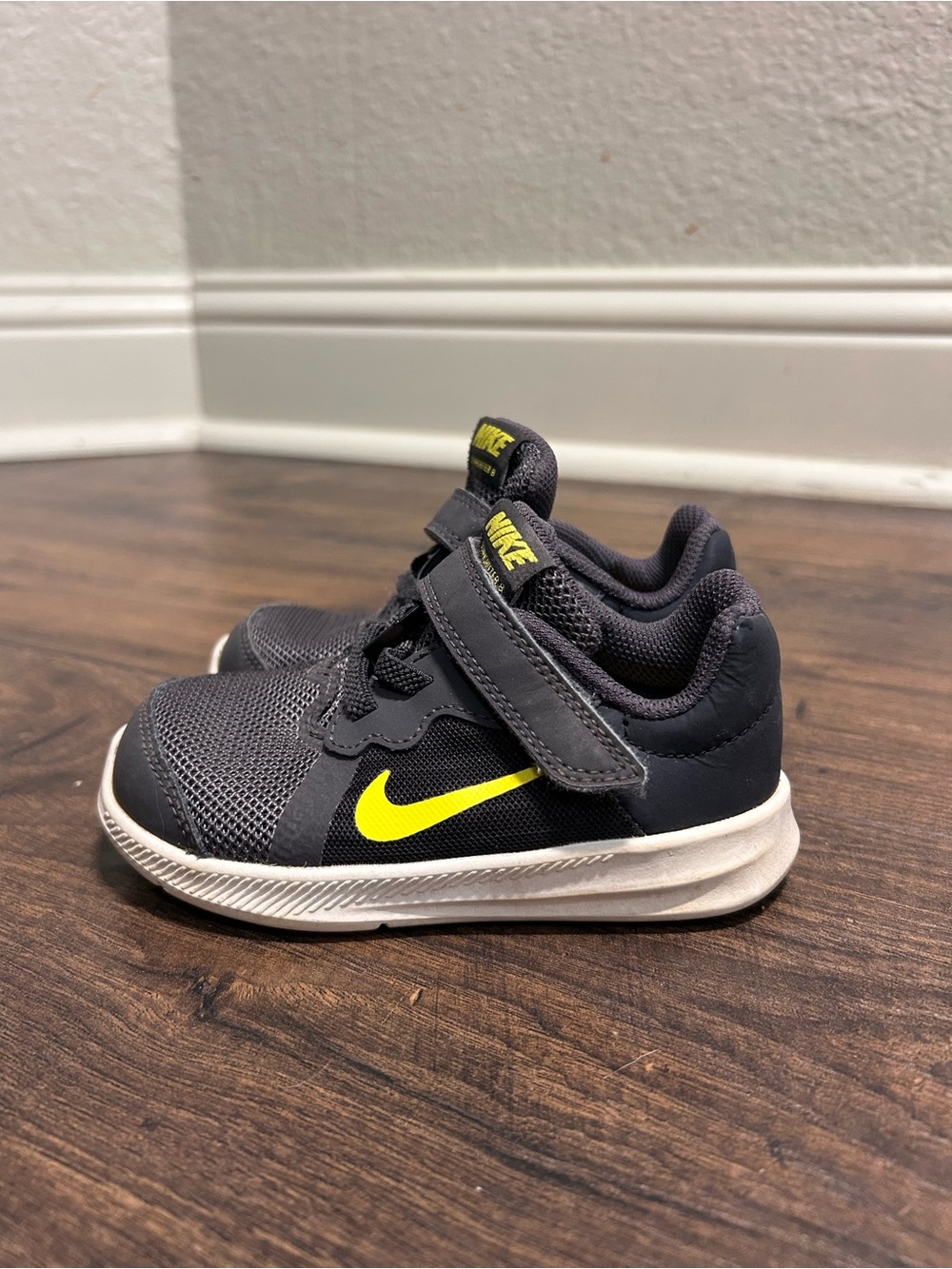 Size 7 Nike toddler Charcoal Gray Sneakers with Yellow Swoosh